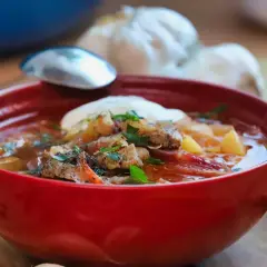 Pyszny barszcz czerwony zabielany, przepis babci. Aromatyczna zupa z kawałkami mięsa, ziemniakami i śmietaną, podana z chlebem.