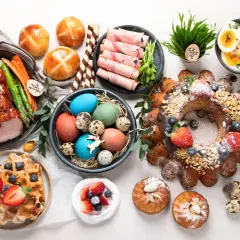 Wielkanocne przekąski: pieczony schab, babka, mazurek, jajka, pascha i słodkie bułeczki.