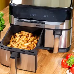 Frytki z frytkownicy beztłuszczowej Tefal, idealne do rankingu air fryer. Obok bazylia i pomidory.