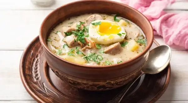 Aksamitny żurek z jajkiem i kiełbasą, czy do żurku dodaje się śmietanę? Tak, dla kremowej konsystencji i bogatszego smaku.