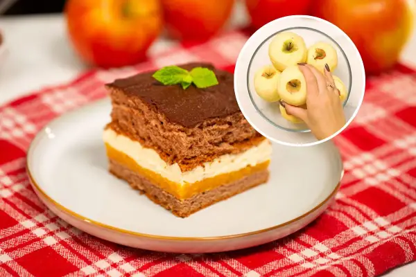 Pyszne ciasto Kilimandżaro z kremem i czekoladą, obok jabłka. W rogu widać rękę wybierającą jabłka do ciasta.